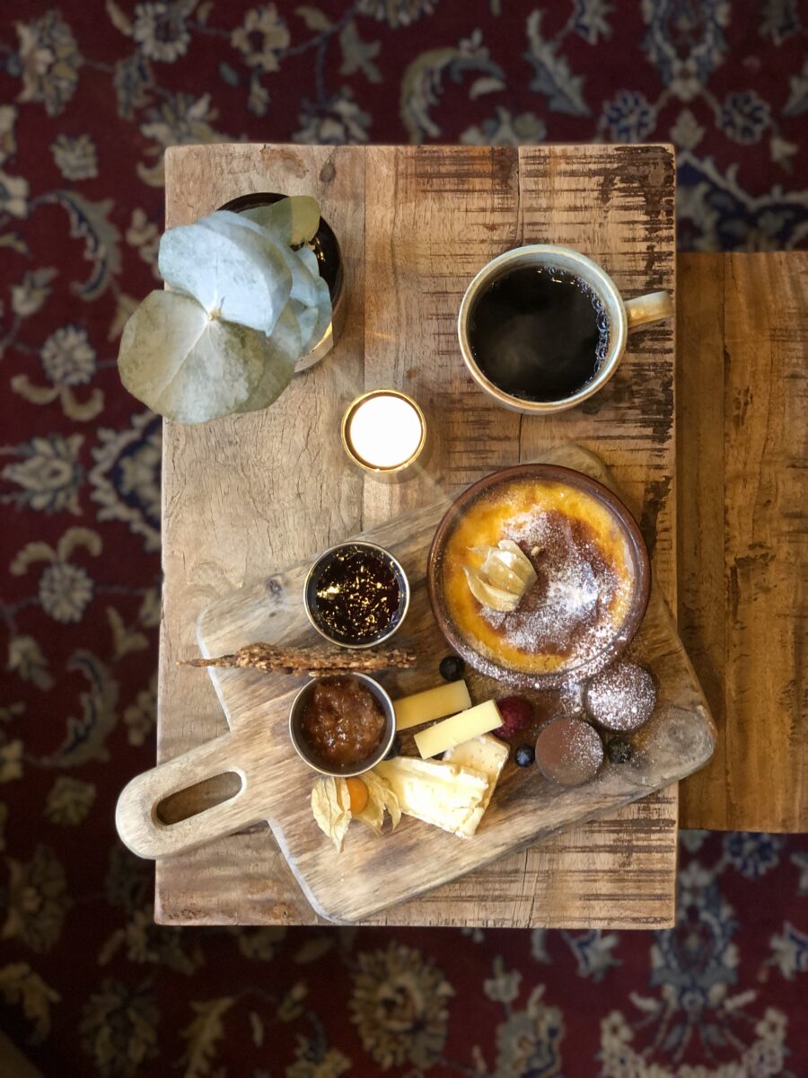Swedish fika: coffee, cheese and crème brûlée on a wooden board