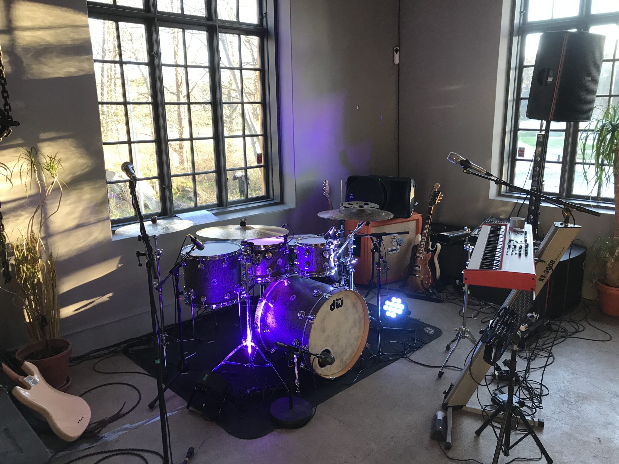 Scenen på Gnistan med trummor, keyboard och gitarrer framför de höga fönstren